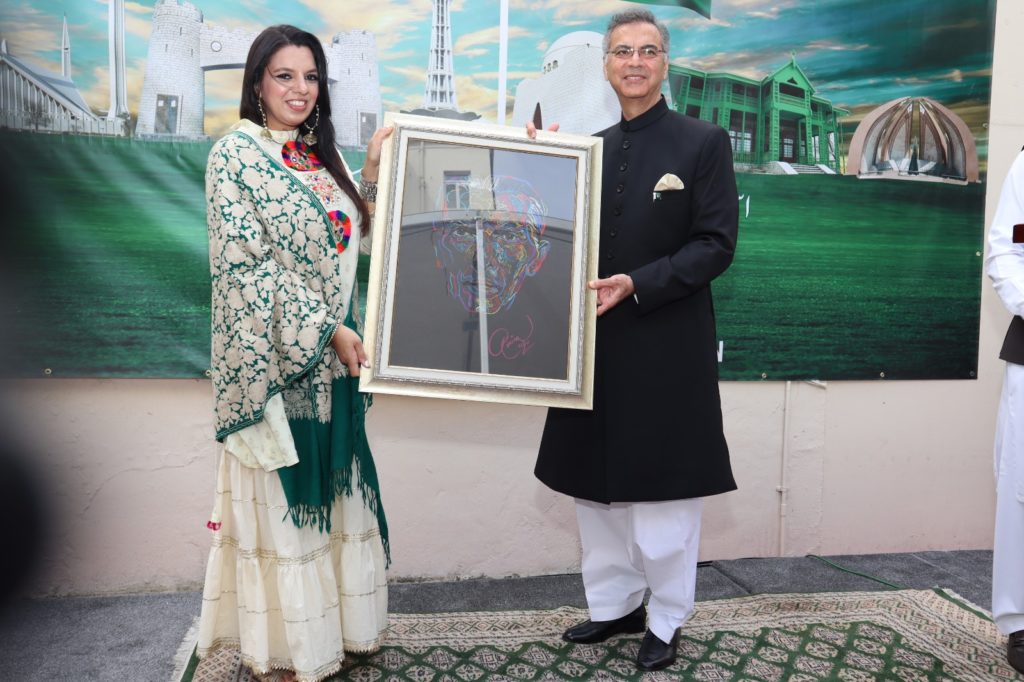 Amina Ansari artist presenting Quaid-i-Azam’s portrait to the High Commissioner at Independence Day ceremony