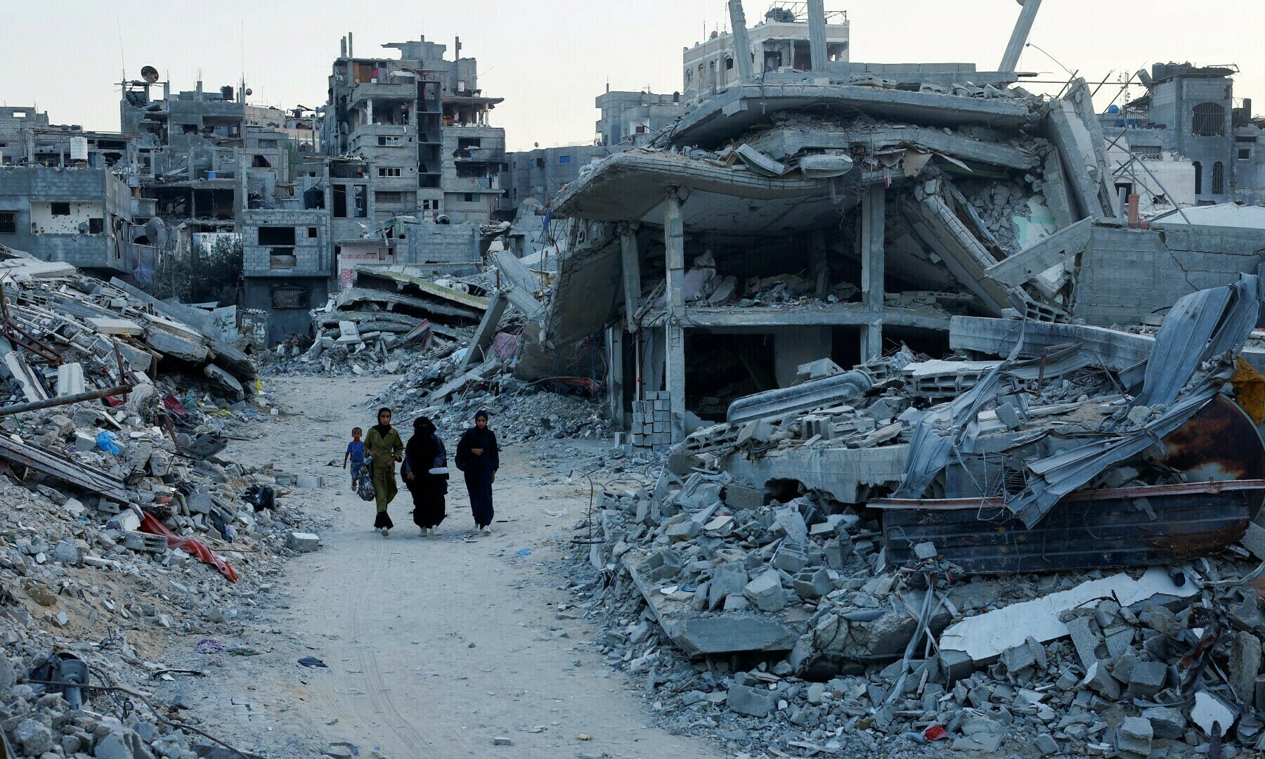 Palestinian walk amidst the rubble of buildings destroyed after an Israeli strike, in Khan Younis, in the southern Gaza Strip on Sept 1, 2024. Image via Reuters