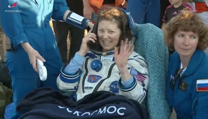 Tracy Dyson quickly got on the phone after being helped out of the space craft (Picture via REUTERS)